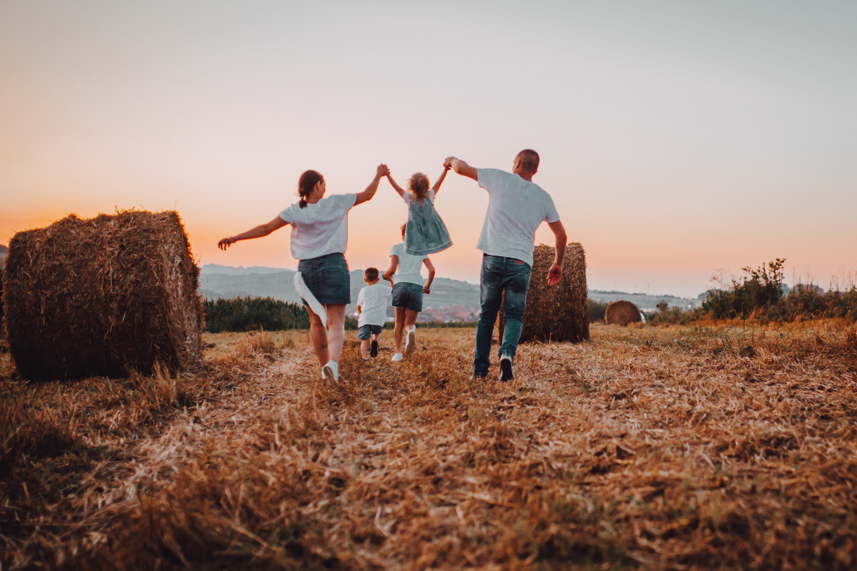 Family in field evaluating their land selling choices